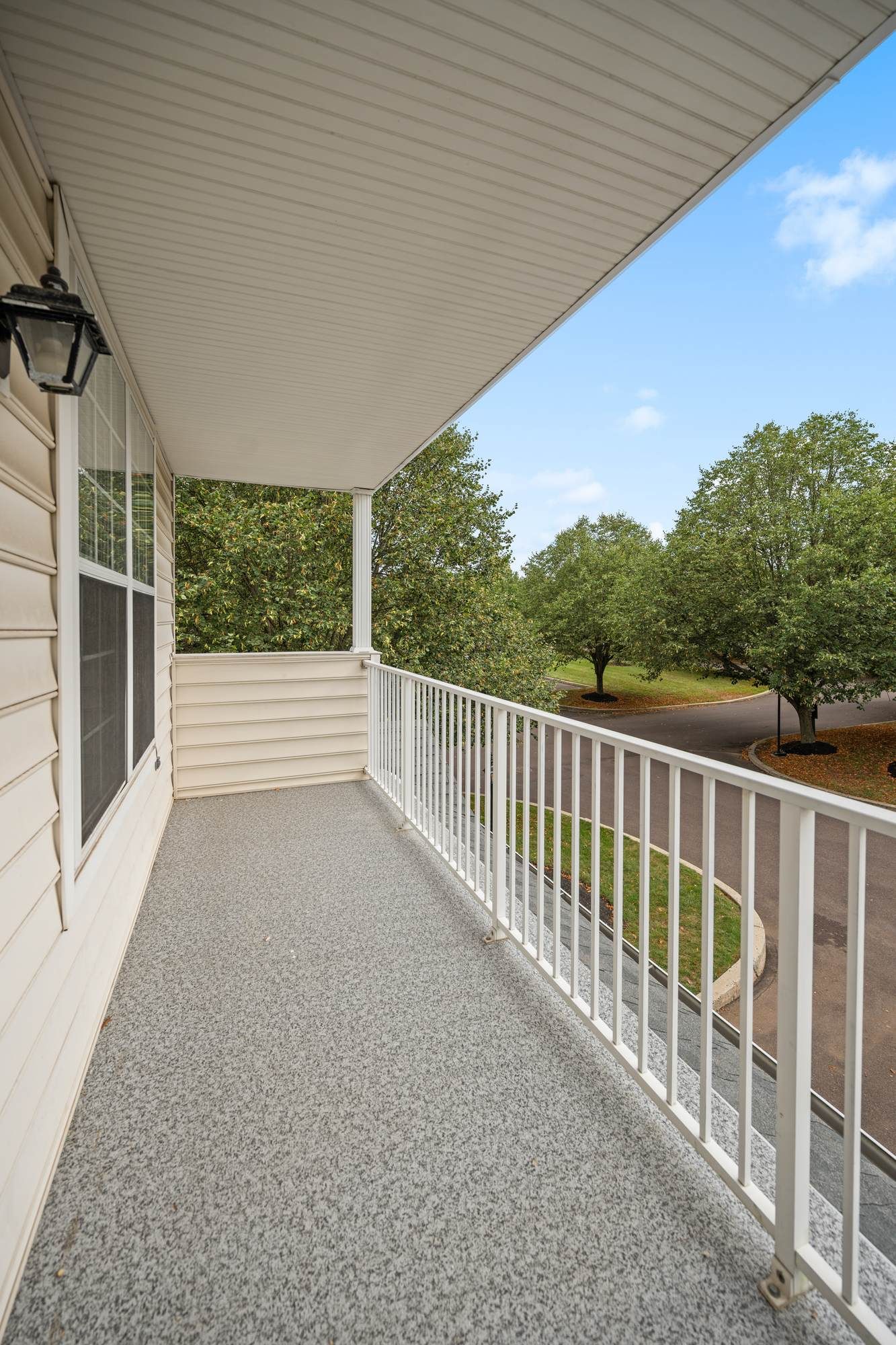 Private balcony overlooking green landscaped areas at Jacobs Woods.