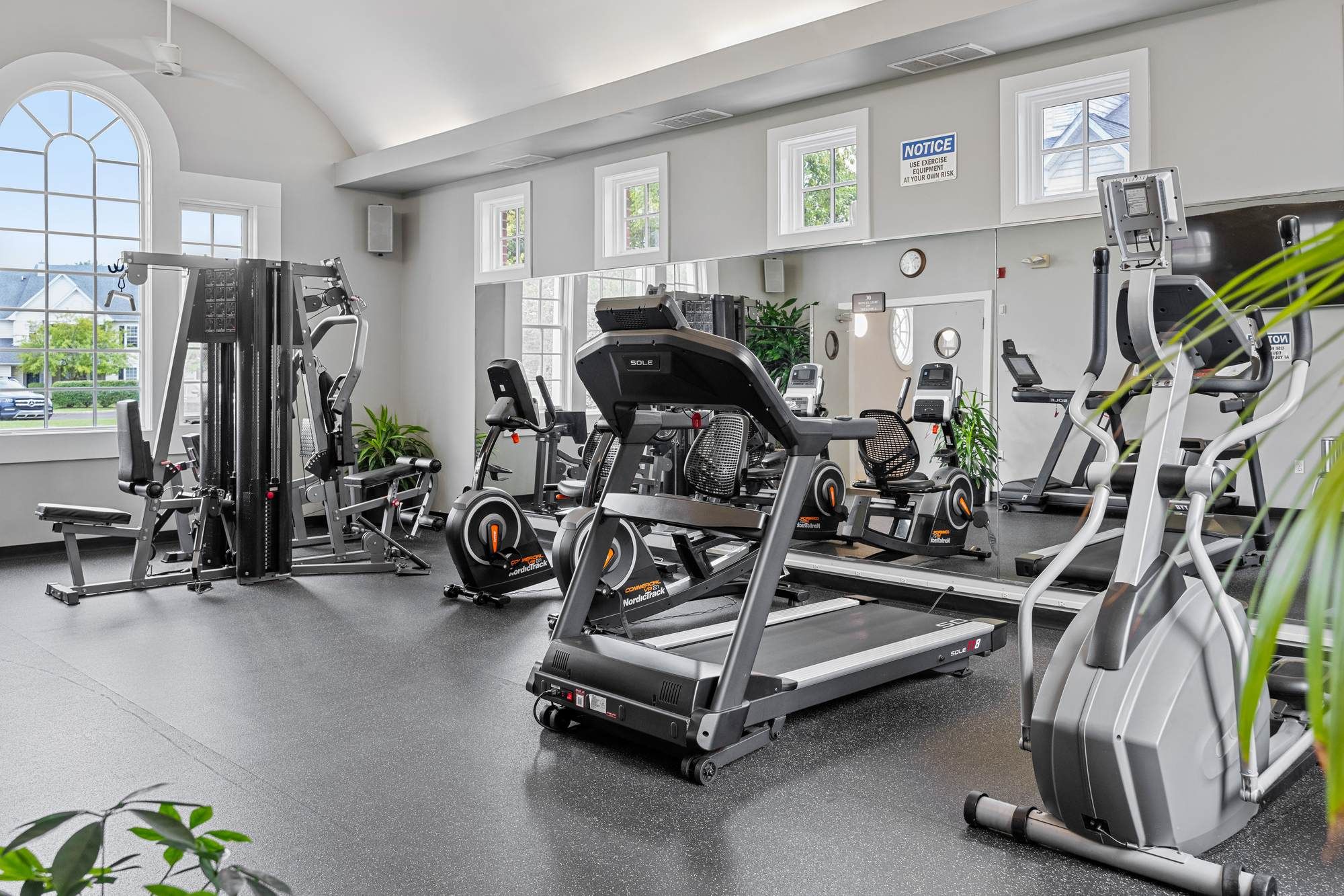 Jacobs Woods fitness center with treadmills, strength equipment, and bright natural light